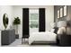 Inviting bedroom featuring stylish furniture, decor, and a large bright window at 9542 Minnow Ray Dr, Land O Lakes, FL 34638