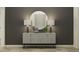 Elegant hallway area with decorative mirror, stylish lamps, and artistic vases on an accent table at 9542 Minnow Ray Dr, Land O Lakes, FL 34638