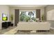 Bright living room with a comfortable sofa, TV, and natural light from the large sliding glass doors at 9542 Minnow Ray Dr, Land O Lakes, FL 34638
