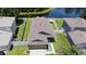 Home aerial view with a fenced backyard, pond access, and well-manicured lawn at 9831 Edmonton Dr, Land O Lakes, FL 34638