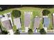 An aerial view of a home with a well-maintained roof, paved driveway, and green surroundings at 9831 Edmonton Dr, Land O Lakes, FL 34638