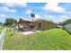 Large backyard with a shaded pergola, perfect for outdoor activities and relaxation at 9831 Edmonton Dr, Land O Lakes, FL 34638