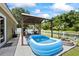 Relaxing backyard with a pool and shaded pergola, perfect for outdoor entertaining at 9831 Edmonton Dr, Land O Lakes, FL 34638