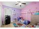 Bright bedroom featuring stylish decor and a modern ceiling fan with complementary colored walls at 9831 Edmonton Dr, Land O Lakes, FL 34638