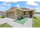 Charming single-Gathering home with a well-kept lawn, two-car garage and inviting front entrance with white rails at 9831 Edmonton Dr, Land O Lakes, FL 34638