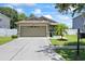 Charming single-story home featuring a well-manicured lawn, neutral paint, and a spacious two-car garage at 9831 Edmonton Dr, Land O Lakes, FL 34638