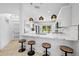 Modern kitchen features white cabinets, a marble-look countertop, pendant lights, and stainless steel appliances at 9831 Edmonton Dr, Land O Lakes, FL 34638