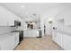 Modern kitchen features white cabinets, stainless steel appliances, and an open design that seamlessly connects to other living spaces at 9831 Edmonton Dr, Land O Lakes, FL 34638