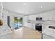 Contemporary kitchen with white cabinets, stainless steel appliances, sliding door access to the pool/lake at 9831 Edmonton Dr, Land O Lakes, FL 34638