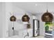 Contemporary kitchen with white cabinets, stainless steel appliances, decorative pendant lighting and access to the patio at 9831 Edmonton Dr, Land O Lakes, FL 34638