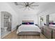 Well-lit main bedroom with a modern ceiling fan, ensuite bathroom, walk-in shower, and neutral decor at 9831 Edmonton Dr, Land O Lakes, FL 34638