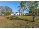 The spacious backyard with mature palm trees and a shed offers plenty of room for outdoor activities at 105 12Th Sw St, Ruskin, FL 33570