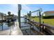 Home features a boat lift on a deep canal with easy access to open water for boating, fishing, and recreation at 105 12Th Sw St, Ruskin, FL 33570