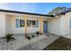Inviting front entrance with decorative columns, blue door, charming shutters and decorative rock landscaping at 105 12Th Sw St, Ruskin, FL 33570
