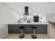 Kitchen island boasts sleek black accents, bar stool seating, and ample counter space for cooking and entertaining at 105 12Th Sw St, Ruskin, FL 33570