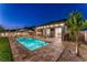 Inviting backyard featuring a pool with water features, cozy lounge seating, and a stunning twilight view at 11828 Ranchers Gap Dr, Odessa, FL 33556