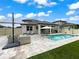 Gorgeous backyard with a pool, outdoor seating, and meticulous landscaping, perfect for entertaining or relaxing at 11828 Ranchers Gap Dr, Odessa, FL 33556