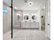 Sleek bathroom featuring dual vanities, a glass shower, and modern fixtures at 11828 Ranchers Gap Dr, Odessa, FL 33556