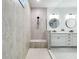 Contemporary bathroom with tiled shower, dual sinks, and elegant design elements at 11828 Ranchers Gap Dr, Odessa, FL 33556