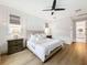 Serene bedroom showcasing wood floors, a ceiling fan, and neutral decor at 11828 Ranchers Gap Dr, Odessa, FL 33556