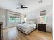 Cozy bedroom with natural light, wood floors, and a tufted headboard at 11828 Ranchers Gap Dr, Odessa, FL 33556