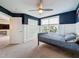 Well-lit bedroom with a gray bed frame, white wainscoting, a large window with blinds, and ample natural light at 11828 Ranchers Gap Dr, Odessa, FL 33556
