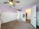 Spacious bedroom featuring a walk-in closet, light lavender walls, white trim and modern ceiling fan at 11828 Ranchers Gap Dr, Odessa, FL 33556