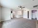 Open bonus room with neutral carpet, a ceiling fan, and access to other areas of the home at 11828 Ranchers Gap Dr, Odessa, FL 33556