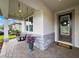 Inviting front porch with a swing, stone accents, a decorative wreath, and a 'Hello' welcome mat at 11828 Ranchers Gap Dr, Odessa, FL 33556