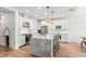 Kitchen with granite countertops, modern stainless steel appliances, white cabinets, and a central island with barstool seating at 11828 Ranchers Gap Dr, Odessa, FL 33556