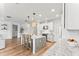 Bright kitchen with island featuring granite countertops, pendant lighting, stainless appliances, and wood-look flooring at 11828 Ranchers Gap Dr, Odessa, FL 33556