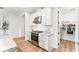 Kitchen featuring granite countertops, stainless steel appliances, white cabinets, a pantry, and wood flooring at 11828 Ranchers Gap Dr, Odessa, FL 33556