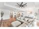 Living room featuring a modern interior design, stylish furniture, and open access to the kitchen and dining areas at 11828 Ranchers Gap Dr, Odessa, FL 33556