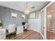 Bright office with a decorative chandelier, modern wall paneling, a spacious desk, and hardwood flooring at 11828 Ranchers Gap Dr, Odessa, FL 33556