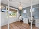 Stylish home office featuring modern wainscoting, a chic chandelier, a double desk, and natural light at 11828 Ranchers Gap Dr, Odessa, FL 33556