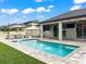 Backyard pool area with lush landscaping, an inviting pool, and outdoor seating, perfect for relaxing and entertaining guests at 11828 Ranchers Gap Dr, Odessa, FL 33556