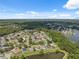 Scenic aerial view of a well-planned residential area with homes, green spaces, and a tranquil lake at 12038 Steppingstone Blvd, Tampa, FL 33635