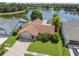 Aerial view of the home, showcasing its lush landscaping and lake view at 12038 Steppingstone Blvd, Tampa, FL 33635