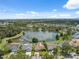 Beautiful aerial view of homes surrounding a serene lake with a fountain in a lush green community at 12038 Steppingstone Blvd, Tampa, FL 33635