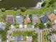 Overhead view of homes, showcasing private pools, manicured lawns, and a quiet cul-de-sac near a serene lake at 12038 Steppingstone Blvd, Tampa, FL 33635