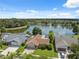 Overhead view of a home near a lake with a fountain in a suburban neighborhood at 12038 Steppingstone Blvd, Tampa, FL 33635