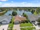 Aerial view of the house, landscaping, and large lake with fountain at 12038 Steppingstone Blvd, Tampa, FL 33635
