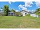 View of the backyard featuring a screened-in porch and green lawn at 12038 Steppingstone Blvd, Tampa, FL 33635
