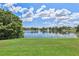 Lush green backyard featuring a scenic view of the large lake at 12038 Steppingstone Blvd, Tampa, FL 33635