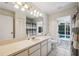 Bathroom featuring a large vanity, outdoor access, and a shower with striped shower curtain at 12038 Steppingstone Blvd, Tampa, FL 33635
