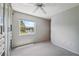 Bedroom with white carpet, gray walls, closet system, and a window overlooking the lake at 12038 Steppingstone Blvd, Tampa, FL 33635