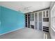 Bedroom with aqua blue walls, white carpet, built-in closet shelving and drawers at 12038 Steppingstone Blvd, Tampa, FL 33635