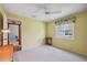Bedroom with white carpet, yellow walls, and a window overlooking the exterior at 12038 Steppingstone Blvd, Tampa, FL 33635