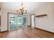 Dining room with modern chandelier, sliding glass doors with pool views, and convenient bar area for entertaining at 12038 Steppingstone Blvd, Tampa, FL 33635