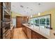 Gourmet kitchen featuring stainless steel appliances, granite countertops, a center island, and views of the outdoor pool at 12038 Steppingstone Blvd, Tampa, FL 33635